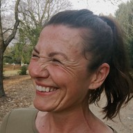 Laughing woman on a park path